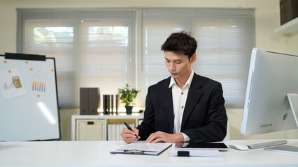 Busy financial specialist man working with finance sales document report and pc laptop computer in office. Mature executive businessman professional check analysing business, invest review