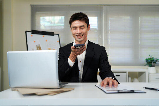 Man using AI voice assistant on smartphone with speech-to-text conversion and chatbot interface, representing smart technology, digital assistant and virtual communication.