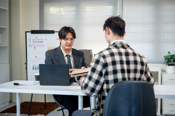 Businessman boss handing document envelopes to coworker employee at working table in company office