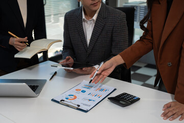 Businessmen team or financial data analysts working with tablets and laptop computers and data...