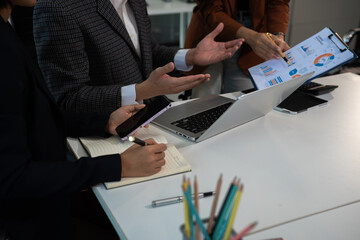Businessmen team or financial data analysts working with tablets and laptop computers and data...