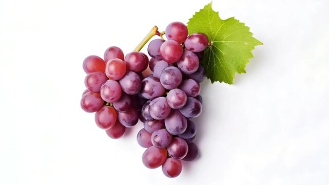 Closeup of a bunch of red grapes with a leaf isolated on white background