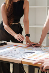 Fototapeta premium Designers collaborating on mobile app user interface development