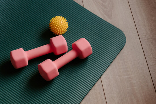 Dumbbells and yoga mat. Sports equipment. Fitness at home concept