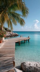 Wooden Tropical Dock Extending Over Crystal Clear Turquoise Ocean Water With Palm Trees and Sunny Sky
