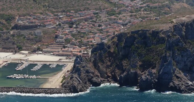 Coastal town Buggerru with marina, rocky cliffs, sunny, Sardegna beauty