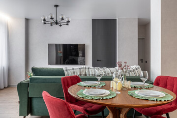 Modern Living Room with Green Sofa and Red Chairs