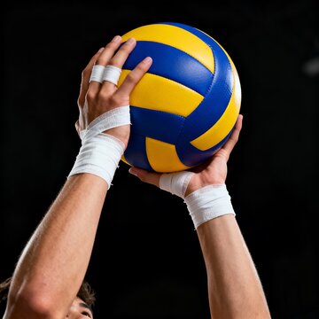 A volleyball player prepares to serve the ball with their hands wrapped in white athletic tape against black