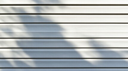 Obraz premium A close-up of textured white panels casting soft shadows, creating a minimalist and serene visual effect.