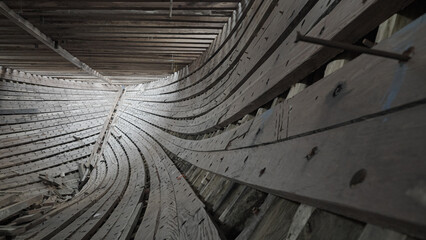 The stringer and frame sections in the construction of a traditional Phinisi wooden ship are linked to each other with bolts and pegs. © Janwar
