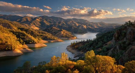 Fototapeta premium Breathtaking Sunset over Lake Berryessa: A Serene Water Landscape Framed by Mountains and Autumn Skies in Napa Valley, California.