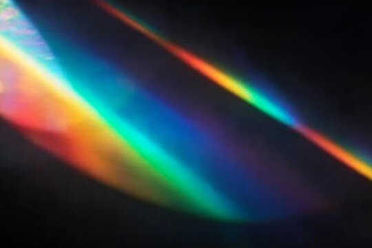 Iridescent crystal light leaks create a dreamy spectrum overlay. Transparent rainbow streaks shimmer across the background. Perfect for photo or vector design.