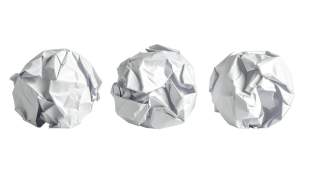 Three crumpled white paper balls on black, studio lighting