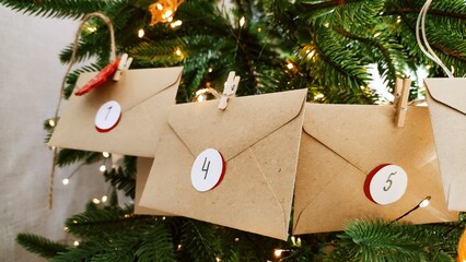 Preparing an Advent calendar for Christmas. Eco-craft envelopes with numbers for children. Christmas background, Advent from small craft envelopes.