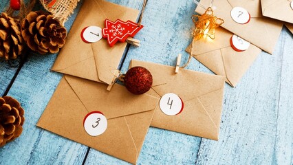Preparing an Advent calendar for Christmas. Eco-craft envelopes with numbers for children. Christmas background, Advent from small craft envelopes.