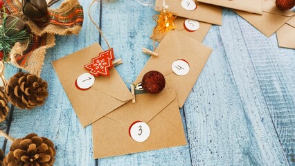 Preparing an Advent calendar for Christmas. Eco-craft envelopes with numbers for children. Christmas background, Advent from small craft envelopes.