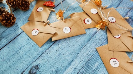 Preparing an Advent calendar for Christmas. Eco-craft envelopes with numbers for children. Christmas background, Advent from small craft envelopes.