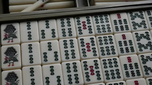 Traditional Mahjong Tiles Set with Circle Dots and Bamboo Sticks Arranged in Wooden Box