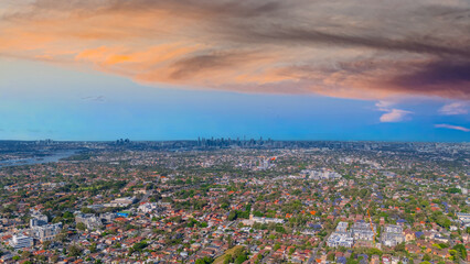 Panorama Sunset  aerial drone view of western Sydney Suburbs of Canterbury Burwood Ashfield Marrickville Campsie with Houses roads and parks in Sydney New South Wales NSW Australia