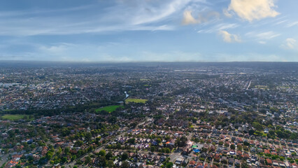 Panorama Sunset  aerial drone view of western Sydney Suburbs of Canterbury Burwood Ashfield Marrickville Campsie with Houses roads and parks in Sydney New South Wales NSW Australia