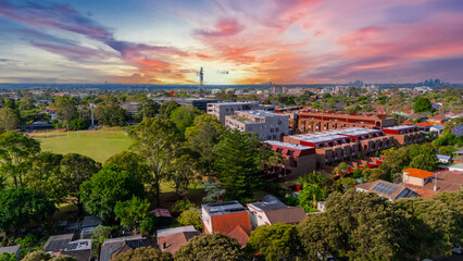 Panorama Sunset  aerial drone view of western Sydney Suburbs of Canterbury Burwood Ashfield Marrickville Campsie with Houses roads and parks in Sydney New South Wales NSW Australia