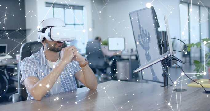 Testing VR headset man in striped shirt manipulating skeletal hand model at office desk, copy space