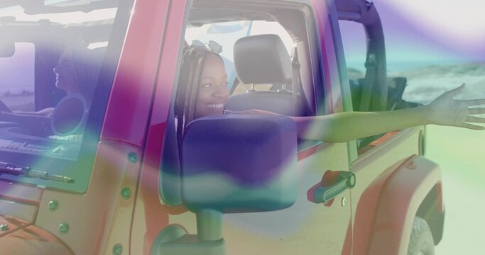 Leaning woman in summer clothes extending arm from red SUV window at sandy beach, with sunglasses - Powered by Adobe