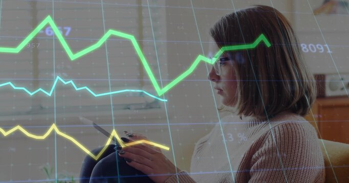 Interacting woman holding tablet, tracing graph overlays on window blinds in lounge, copy space