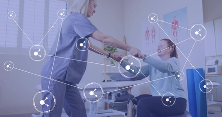 Patient and therapist in scrubs performing arm exercise in clinic, with stability ball, copy space