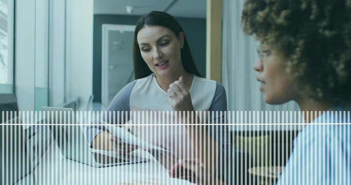 Reviewing documents businesswoman explaining in business meeting, with laptop smartphone on table