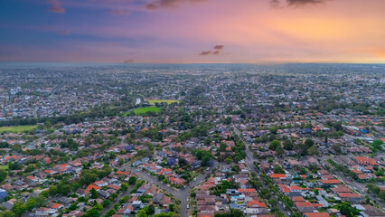 Panorama Sunset  aerial drone view of western Sydney Suburbs of Canterbury Burwood Ashfield Marrickville Campsie with Houses roads and parks in Sydney New South Wales NSW Australia
