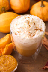 Pumpkin Spice Latte. A cozy pumpkin spice latte with whipped cream, surrounded by pumpkins