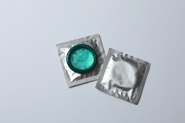 Close-up of a condom on a white background, wrappers in a square and rectangular package on a white background (adult content) - clipping path.

