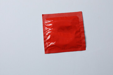 Close-up of a condom on a white background, wrappers in a square and rectangular package on a white background (adult content) - clipping path.
