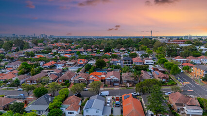 Panorama Sunset  aerial drone view of western Sydney Suburbs of Canterbury Burwood Ashfield Marrickville Campsie with Houses roads and parks in Sydney New South Wales NSW Australia