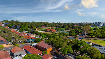 Obraz premium Panorama Sunset aerial drone view of western Sydney Suburbs of Canterbury Burwood Ashfield Marrickville Campsie with Houses roads and parks in Sydney New South Wales NSW Australia