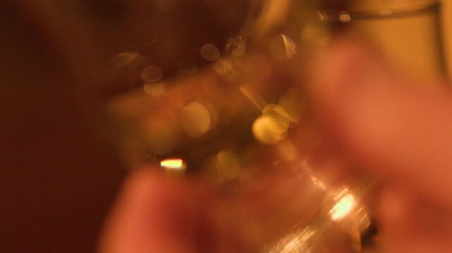 Swirling Whisky Glass in Warm Scottish Distillery Light