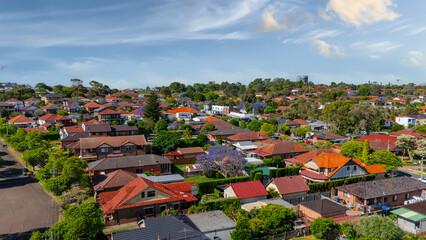 Panorama Sunset  aerial drone view of western Sydney Suburbs of Canterbury Burwood Ashfield Marrickville Campsie with Houses roads and parks in Sydney New South Wales NSW Australia