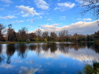 autumn trees reflection on the lake in the park, evening, melancholic