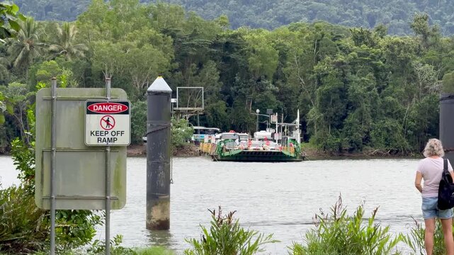 Vehicle Ferry Approaching Riverbank in Tropical Queensland Landscape