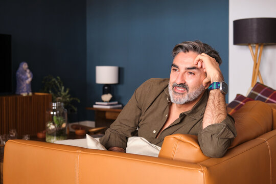 Relaxed man on sofa enjoying tranquility and comfort at home