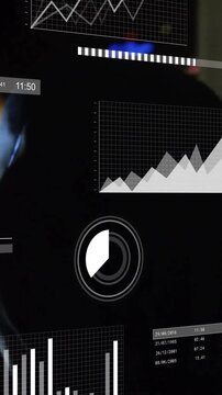 Animation of infographic interface over caucasian businessman working over tablet in office at night