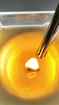 Lighting a decorative scented candle with a lighter