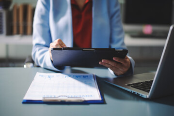 Professional using digital tablet in modern office, symbolizing technology, innovation, productivity, and teamwork in business communication and digital workflow.