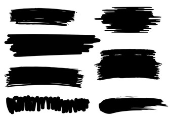 Collection of black brush stroke elements and scribbles on a white background, perfect for graphic design and artistic projects