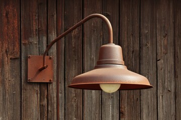 Rustic Gooseneck Lamp Illuminating Wooden Barn Wall, Perfect for Exterior Warehouse Spaces