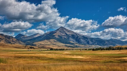 Fototapeta premium Scenic View of Bridger Mountains Near Bozeman, Montana: Majestic Peaks Surrounded by Verdant Hills and Dramatic Skies