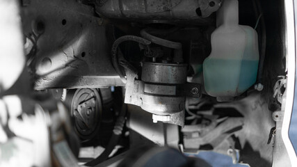 car oil filter. car without wheel, windshield washer fluid, fuel filter replacement. close-up, night light