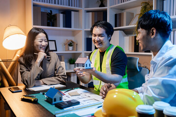 Architects and engineers work together in an office to review blueprints, exchange ideas, and refine their building plans for a contemporary construction project in an urban setting.