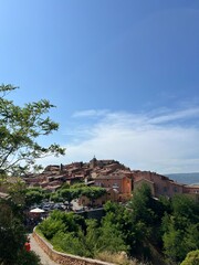 Picturesque hilltop village with stone houses overlooking a vast valley in Provence, France